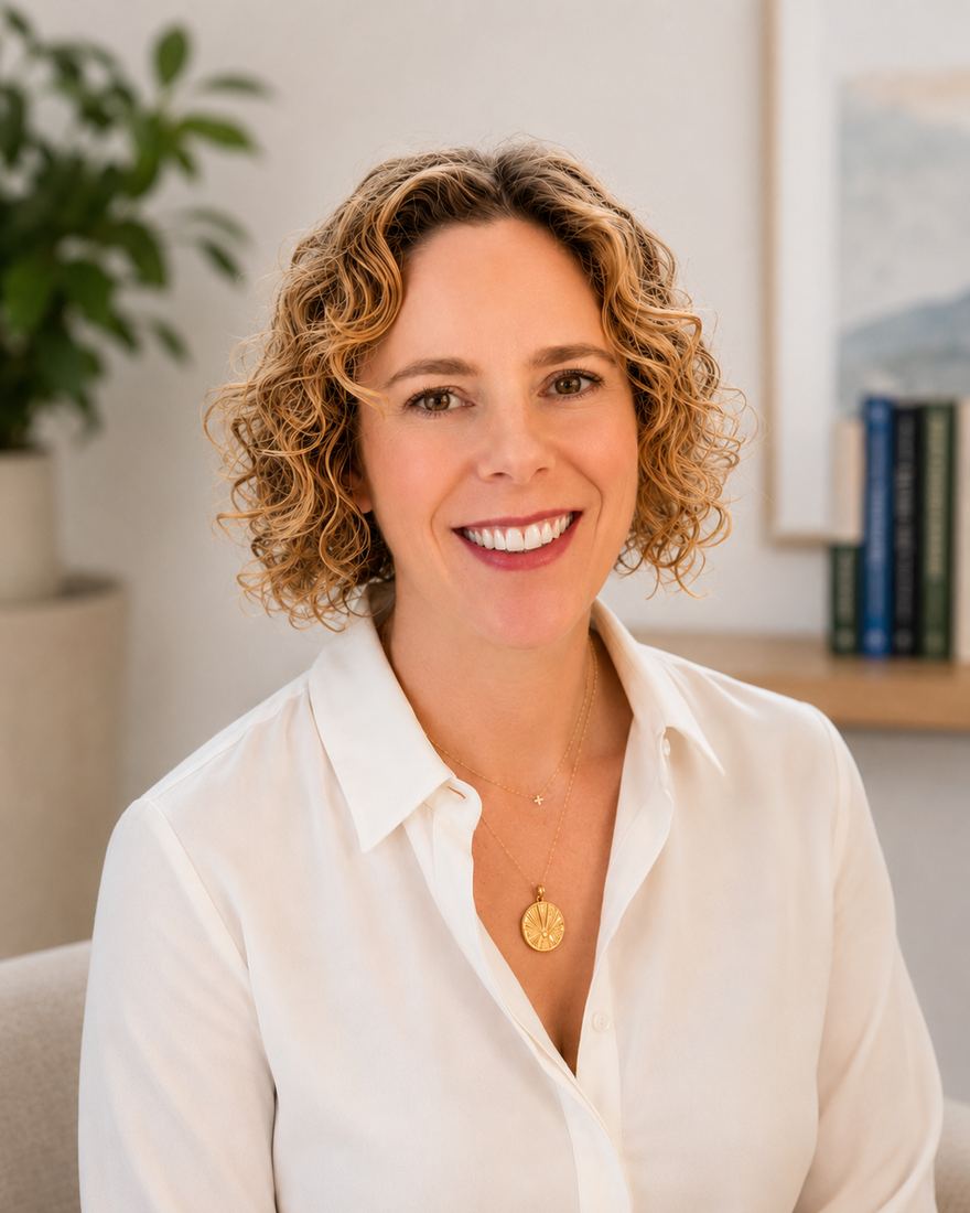 Mandy Spanier, a life transition coach in Tulsa, Oklahoma, smiling warmly in a softly lit indoor portrait.